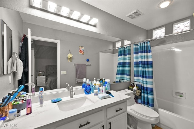 full bathroom with vanity, shower / bath combination with curtain, and toilet