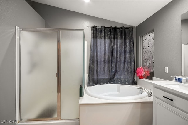 bathroom with lofted ceiling, shower with separate bathtub, and vanity