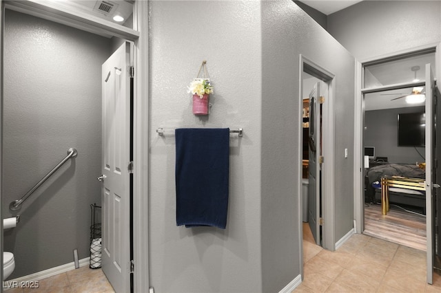 bathroom with tile patterned floors, ceiling fan, and toilet