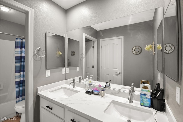 full bathroom with shower / bathtub combination with curtain, vanity, and toilet