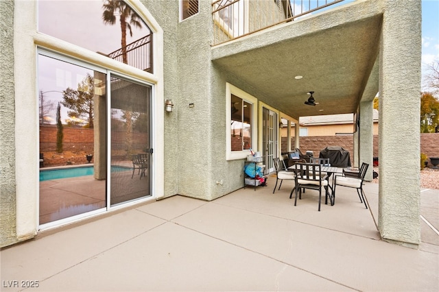 view of patio with a grill and a balcony