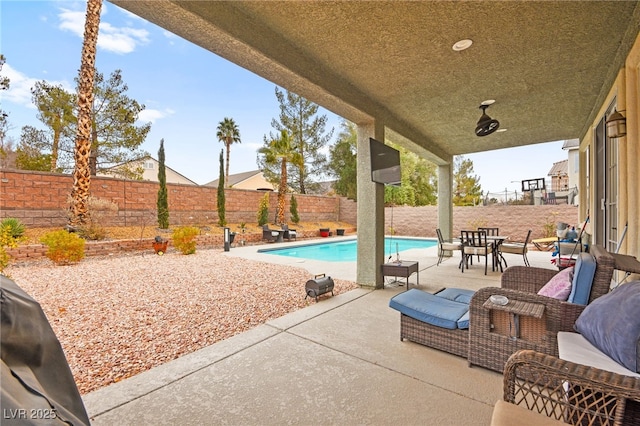 view of patio with a fenced in pool