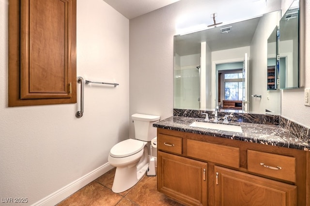 bathroom featuring a shower with door, vanity, tile patterned floors, and toilet