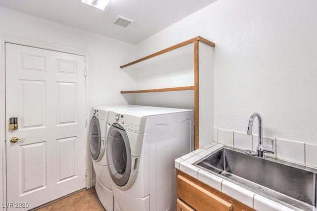 laundry room featuring sink and washing machine and clothes dryer