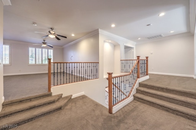 stairs featuring ornamental molding and carpet floors