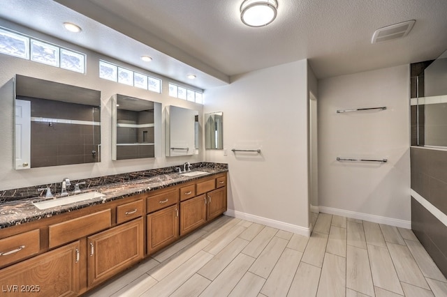 bathroom featuring vanity and a textured ceiling