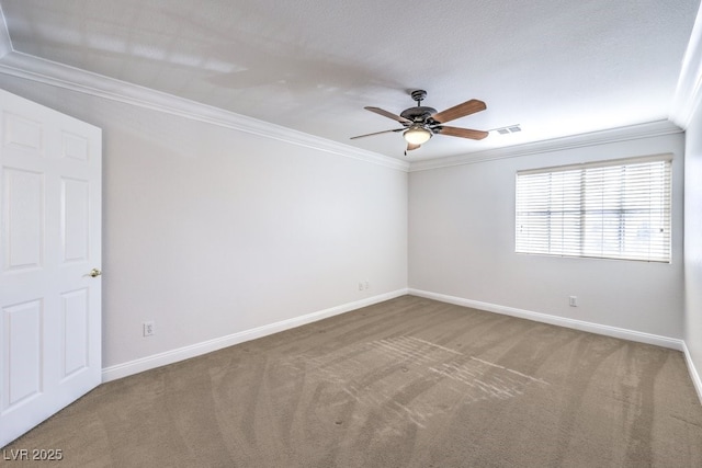 empty room featuring crown molding, ceiling fan, and carpet