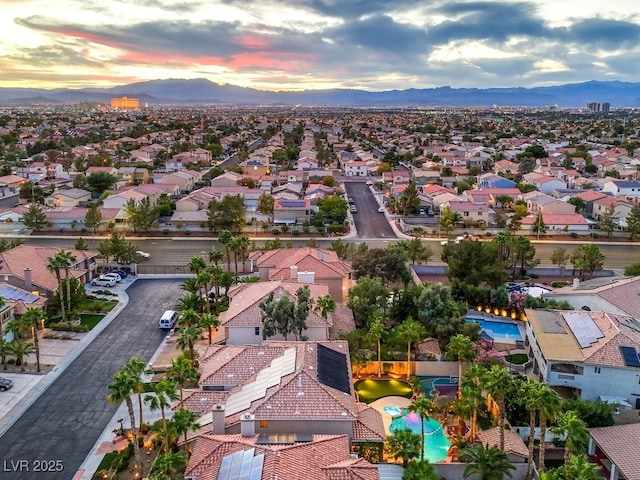 aerial view at dusk featuring a mountain view