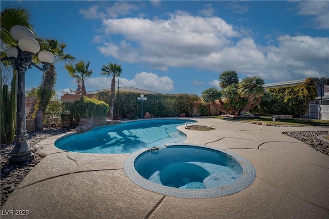 view of pool with an in ground hot tub and a patio