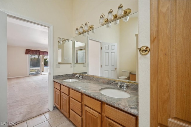 bathroom featuring vanity, toilet, and tile patterned flooring