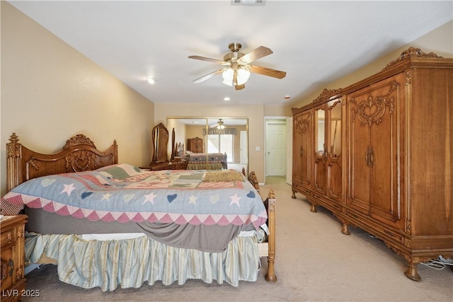 bedroom with light carpet and ceiling fan