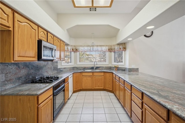 kitchen with sink, gas cooktop, dishwasher, black oven, and kitchen peninsula