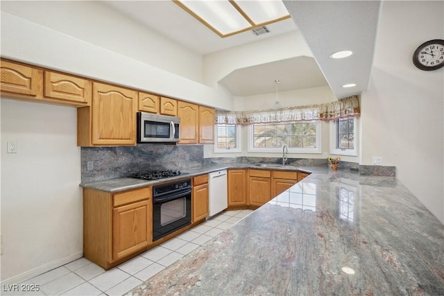 kitchen featuring sink, light tile patterned floors, black appliances, decorative backsplash, and kitchen peninsula