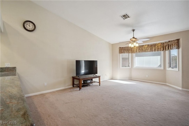 unfurnished living room with ceiling fan, vaulted ceiling, and light carpet