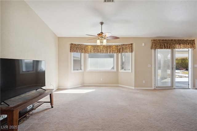 unfurnished living room featuring ceiling fan and carpet flooring