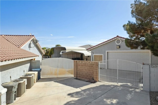 exterior space featuring a garage, central AC, and a carport