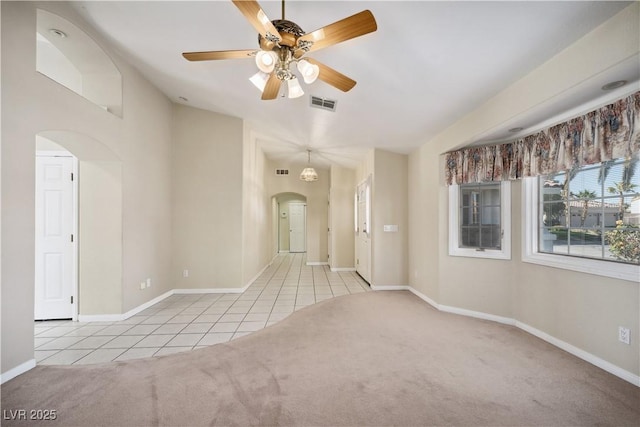 unfurnished room with ceiling fan and light carpet