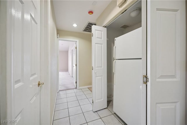 hall with light tile patterned floors