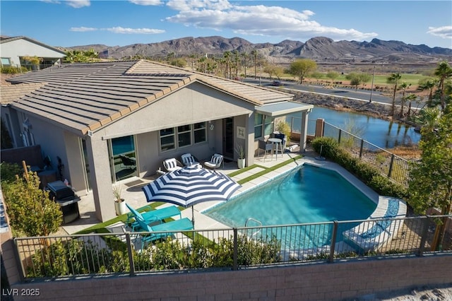 view of pool featuring a grill, a mountain view, and a patio area