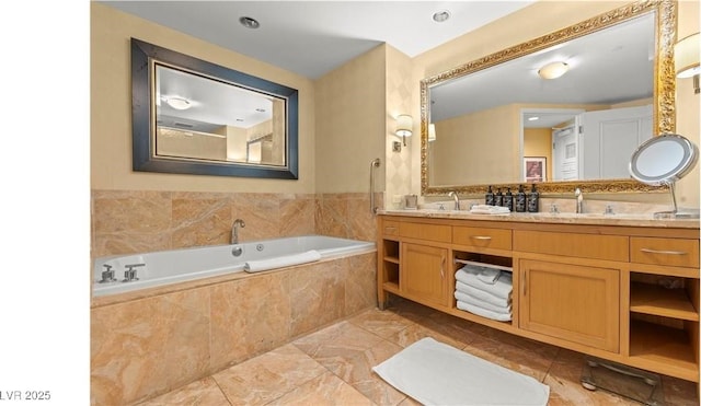 bathroom featuring vanity and tiled tub