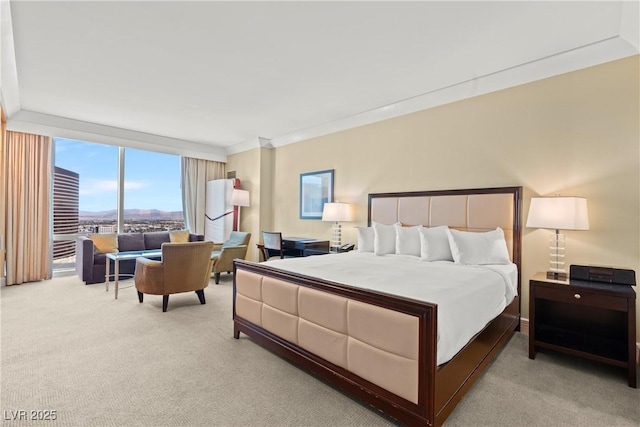 carpeted bedroom featuring crown molding and expansive windows