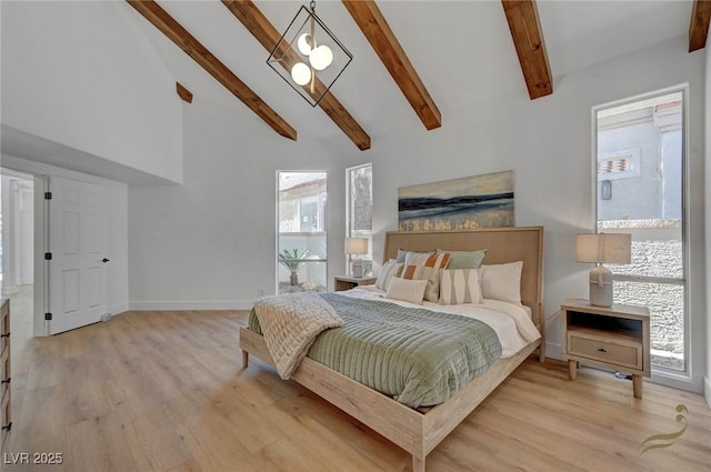 bedroom featuring beam ceiling, high vaulted ceiling, and light hardwood / wood-style flooring