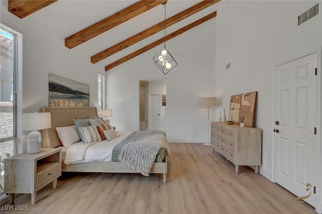 bedroom featuring beamed ceiling, high vaulted ceiling, and light hardwood / wood-style floors