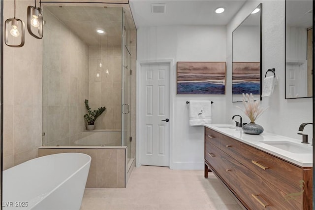 bathroom featuring vanity, tile patterned floors, and plus walk in shower