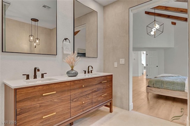 bathroom featuring vanity, hardwood / wood-style floors, and beam ceiling