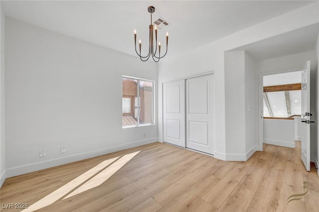 interior space featuring a chandelier and light wood-type flooring