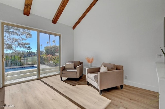 sitting room featuring beamed ceiling, high vaulted ceiling, and light hardwood / wood-style floors