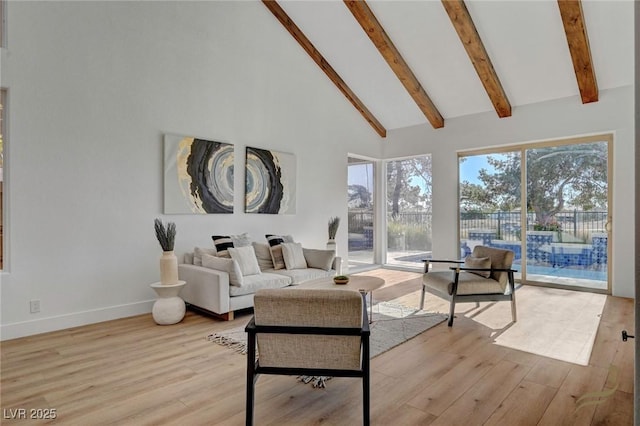 living room featuring beamed ceiling, high vaulted ceiling, and light hardwood / wood-style floors