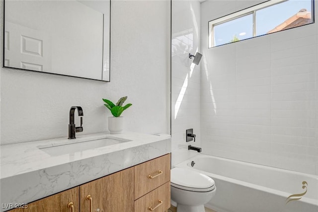 full bathroom with washtub / shower combination, vanity, and toilet