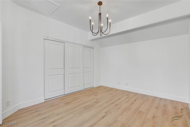 unfurnished dining area with an inviting chandelier and light hardwood / wood-style floors