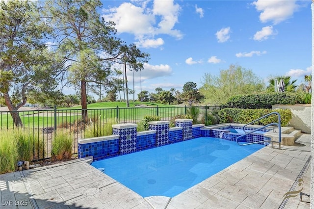 view of pool with an in ground hot tub, pool water feature, and a patio area