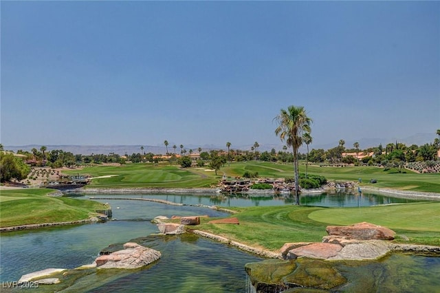 view of property's community featuring a water view and a lawn