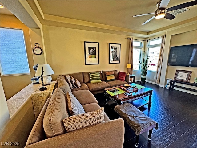 living room with ceiling fan and dark hardwood / wood-style flooring