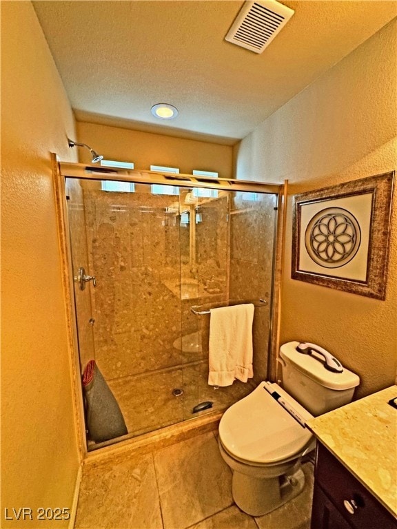 bathroom with an enclosed shower, vanity, a textured ceiling, and toilet