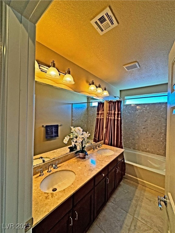 bathroom featuring vanity and a textured ceiling