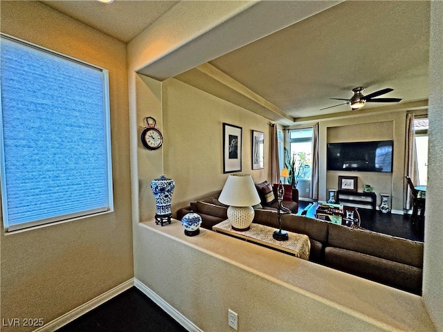 living room with a healthy amount of sunlight and ceiling fan