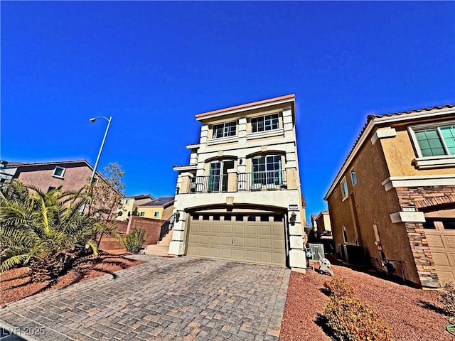 view of front facade with a garage and a balcony