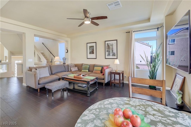 living room with dark wood-type flooring and ceiling fan