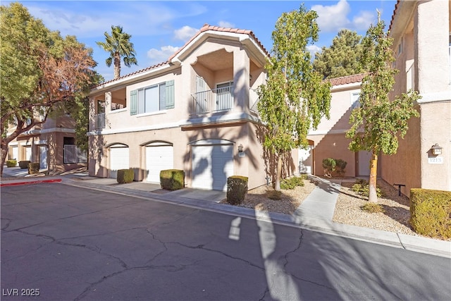 view of front of property featuring a garage and a balcony