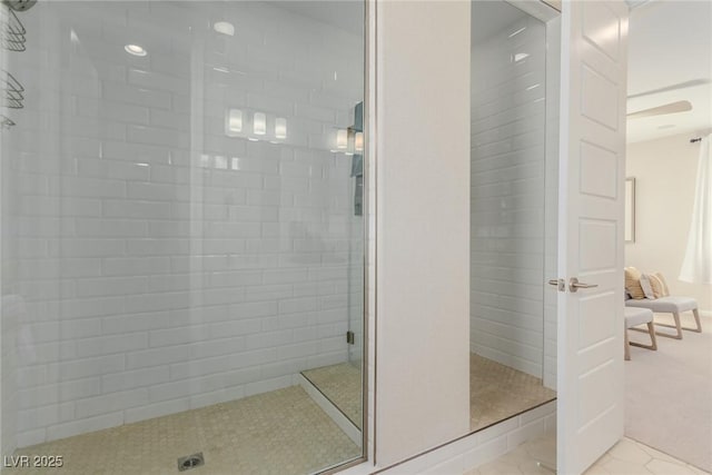 bathroom featuring tile patterned flooring and tiled shower