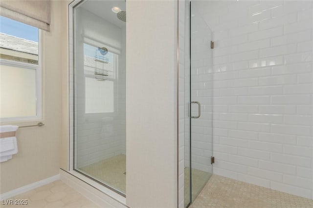 bathroom with a shower with door