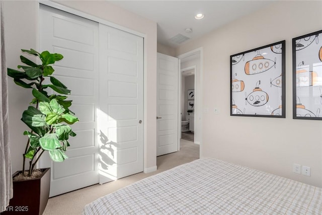 bedroom with light colored carpet and a closet