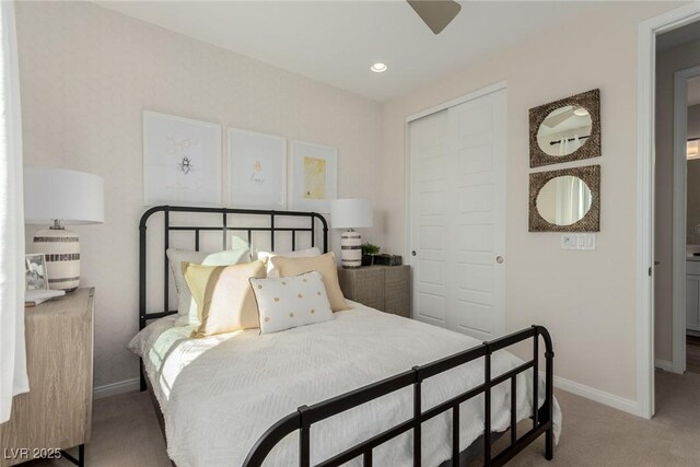 carpeted bedroom with ceiling fan and a closet