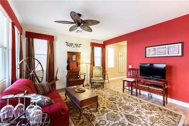 living room featuring hardwood / wood-style flooring and ceiling fan