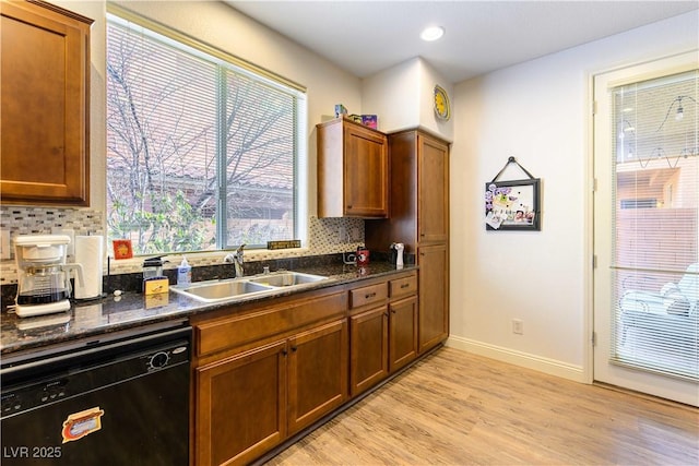 kitchen featuring sink, backsplash, light hardwood / wood-style flooring, and dishwasher