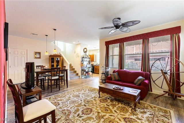 living room featuring hardwood / wood-style flooring and ceiling fan